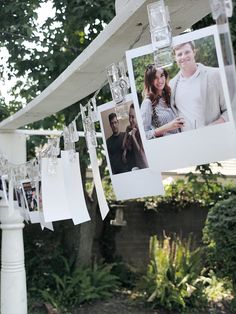 several pictures hanging from a line with clothes pins attached to them and photos pinned to the line