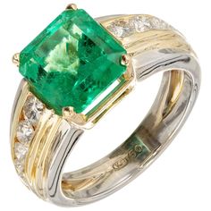 Emerald and diamond engagement ring. Bright green emerald natural color center stone in an 18k yellow and white gold setting with channel set side diamonds. Moderate natural inclusions. GIA certified Colombian origin 1 octagonal bright green Colombian Emerald, approx. total weight 4.02cts, moderate inclusions, 10.32 x 9.37 x 7.06mm, F1 slight clarity enhancement, GIA certificate #2175271429 10 round full cut diamonds, approx. total weight .80cts, G, VS1 – SI1 Size 7.75 and sizable 18k yellow and Luxury Channel Set Emerald Ring For Anniversary, Luxury Green Channel Set Rings, Luxury Emerald Rings Channel Set, Luxury Emerald Rings With Channel Set, Luxury Formal Emerald Ring With Channel Set, Green Diamond Channel Set Rings, Luxury Channel Set Emerald Ring For Formal Occasions, Fine Jewelry Green Channel Set Ring, Elegant Green Channel-set Rings