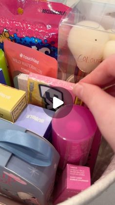 a person holding a container filled with different types of soaps and toothbrushes