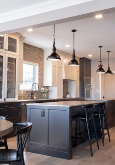 a kitchen with an island and bar stools