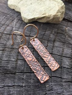 Each set of earrings is individually handcrafted and textured so expect some slight variations that make each pair unique and one-of-a-kind. These earrings are perfect for everyday wear and are customizable as far as the ear wires (choose from bronze, copper or Sterling) and length of the bar. Your earrings will arrive attractively packaged and ready for gifting or for keeps! MEASUREMENTS & SPECIFICS:METAL: pure organic copper LENGTH: 4cm as shown or request a custom lengthWIDTH: approx 8mmF Unique Copper Earrings As Gift, Copper Earrings Handmade Rustic, Copper Earrings Handmade Rustica Jewelry, Hammered Copper Earrings Rustica Jewelry, Unique Silver-colored Copper Earrings, Etched Copper Jewelry, Jewelry Casting, Copper And Wood, Metalsmith Jewelry