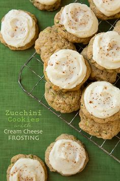 zucchini cookies with cream cheese frosting on a cooling rack and green cloth