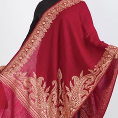 Our new Durga Embroidered Shawl features exquisite embroidery on soft 100% merino wool. With a stunning paisley design, this classically beautiful shawl showcases the intricate embroidery traditions of Northern India in rich gold tones on a burgundy red base. The high quality and elegance of these embroidered shawls make them treasures that will last for generations. Elegant Winter Festive Pashmina Shawl, Elegant Winter Festive Dupatta, Red Pashmina Shawl With Resham Embroidery For Festivals, Traditional Formal Dupatta With Gold Embroidery, Traditional Gold Embroidered Dupatta For Formal Occasions, Elegant Shawl With Embroidered Border For Traditional Ceremonies, Elegant Embroidered Scarves For Festive Occasions, Elegant Red Scarf For Festive Season, Elegant Red Festive Scarf