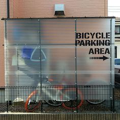 a bicycle parking area behind a fence with the words bicycle parking area on it's side