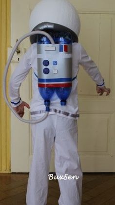 a man dressed in an astronaut suit with a hose attached to his head and arms