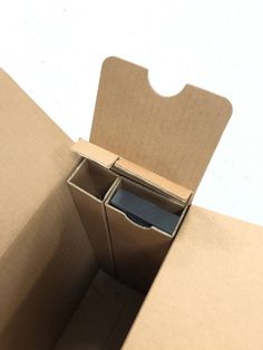 an open cardboard box with a cell phone in it