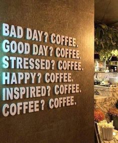 there is a sign on the wall that says bad day? coffee, good day? coffee stressed? coffee happy? coffee inspired? coffee inspired? coffee