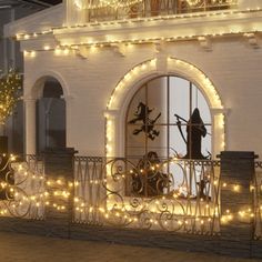 a balcony decorated with christmas lights and decorations