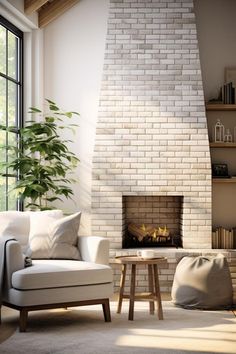 a living room filled with furniture and a fire place in front of a brick fireplace