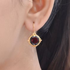 Garnet Vermeil 14K Gold Over Sterling Silver Earring 925 Silver = 4.40 gm. Garnet = 8.10 ct. Garnet is the birthstone for January and is a symbol of friendship. The beautiful earring measures to be 1 inches long including the wire and 0.65 inches wide at its maximum points. The earrings have been made by a team of highly trained and skilled artisans. What is Vermeil 14K Gold? It is a thick layer of 14K Gold plating on 925 Sterling Silver. If for any reason you are not completely satisfied, you m Gold Plated Round Cut Earrings For Gift, Round Birthstone Earrings For Her, Birthstone Earrings As Gift For Her, Round Birthstone Jewelry For Celebration, Round Birthstone Earrings Gift For Her, Classic Gemstone Earrings As Gift, Classic Gemstone Earrings Perfect As Gifts, Classic Gemstone Earrings For Gift, Gold Earrings With Round Birthstone