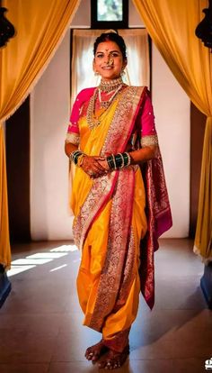 a woman in a yellow and red sari