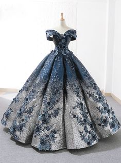 This ball gown by Kemedress is the epitome of winter wonderland luxury. It features thousands of deep blue and silver sequins that sit alongside textured blue floral appliques to create the look of a royal princess. The sweetheart neckline is accentuated by a dramatic off-the-shoulder cut for an amazing fit. Wedding Dress Trumpet, डिजाइनर कपड़े, Sequin Ball Gown, Vintage Ball Gowns, Sweet 15 Dresses, Floor Length Wedding Dress, Blue Ball Gowns, Floral Prom Dresses, Lace Ball Gowns