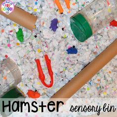 a pile of plastic bottles and toys on top of a floor covered in confetti