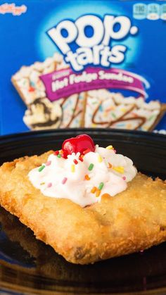 a pop tarts dessert with whipped cream and sprinkles on a black plate