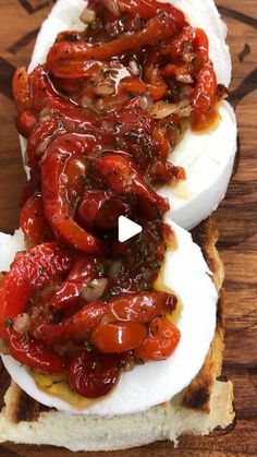 an open face sandwich topped with tomatoes and cheese