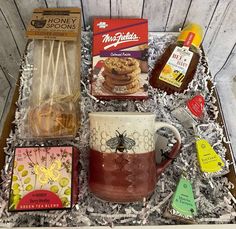 an assortment of food and drink items in a gift box for someone's special occasion