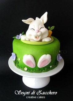 a green cake with white rabbit on top