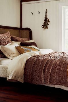 a bed sitting in a bedroom next to a window