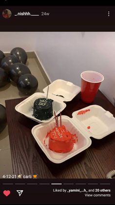 a table topped with plastic containers filled with cake