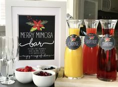 a table topped with wine glasses filled with fruit next to a sign that says merry mimosa bar