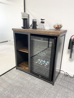 an empty wine cooler in the corner of a room