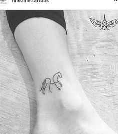 a small tattoo on the ankle of a woman's foot, depicting a horse