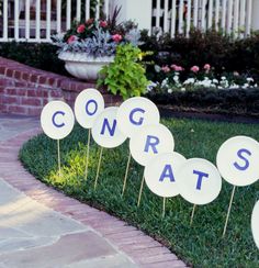 there are some signs that say congrats on the grass