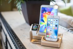 an apple watch and cell phone are sitting on the table next to eachother