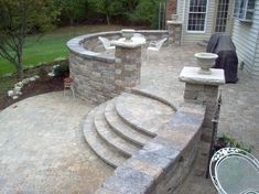 an outdoor patio with stone steps and seating