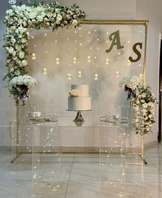 a table topped with white flowers next to a cake