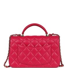 This Mini Top Handle Rectangular flap bag is in fuschia lambskin with light gold tone hardware and has a front flap with signature CC turnlock closure, rear half moon pocket, dark and fuschia top handle and single interwoven fuschia leather and light gold tone chain link shoulder/crossbody strap.The interior is lined in fuschia leather and features a zipper pocket with Chanel pull and an open pocket below.Collection: 2021 (RFID)Origin: FranceCondition: Pre-owned; Mint - This bag retains its shape. The exterior leather is clean with no signs of wear except a few small press marks to back exterior pocket from chain strap. There's no plastic on the hardware but no signs of scratching. The interior leather is clean with no signs of wear.Accompanied by: Chanel box, Chanel dustbag, RFID chip Mea Pink Leather Shoulder Bag With Cc Turnlock Closure, Classic Pink Flap Bag With Top Handle, Classic Pink Top Handle Flap Bag, Pink Flap Bag For Formal Occasions, Pink Formal Flap Bag, Pink Leather Bag With Cc Turnlock Closure, Pink Leather Double Flap Bag, Designer Pink Double Flap Shoulder Bag, Pink Designer Double Flap Shoulder Bag