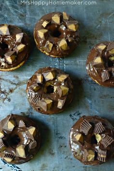 chocolate peanut butter donuts on a baking sheet with the words reese's cup chocolate peanut butter donuts