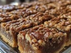 there are many pieces of pecan pie on the tray