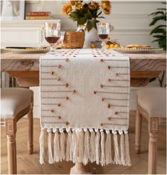 the table is set with an elegantly decorated place mat and two glasses of wine