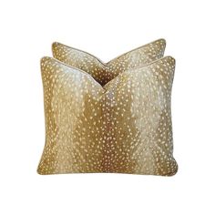 two gold pillows with white spots on them