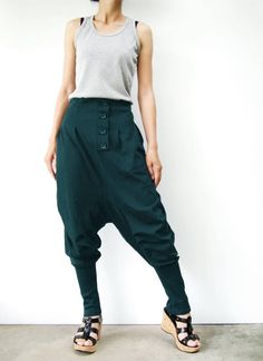 "* ALL ORDERS ARE SHIPPED VIA DHL EXPEDITED MAIL * Cotton jersey harem pants feature a drop crotch design with tapered pant legs, pleated front detail, side seam pockets, elastic back waistband, ribbed cuffs and four tucks at inseam create volume through leg. Roll up the ribbed cuffs hem for an utlra relaxed look! * Pull-on style * decorative pleats front and buttons detailed * Elastic back waistband provides a personal fit * Four tucks at inseam * Side seam pockets * Wide ribbed cuffs Measureme Baggy Tapered Pants With Button Closure, Green Baggy Bottoms For Fall, Green Bottoms With Button Closure, Casual Green Pants With Buttons, Baggy High-waist Buttoned Pants, Green Cotton Pants With Buttons, Baggy High-waist Pants With Buttons, Baggy High Waist Pants With Buttons, Green Bottoms With Buttons For Fall