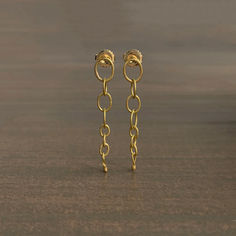 Exquisitely handcrafted gold ovals cascade and dance with seemingly impossible fluidity. 

18k gold posts 
22k yellow gold ovals, 1/4" at the widest 
Earrings hang 1 5/8" from the ear 
Each earring weighs 1.3g Ring Earrings