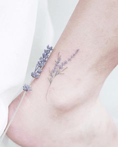 a small lavender tattoo on the ankle