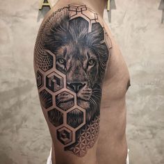 a man with a lion and honeycomb tattoo on his arm