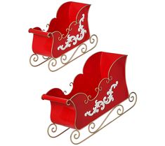 two red sleighs with white designs on them