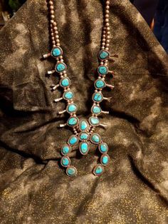 Vintage Navajo Squash Blossom Turquoise Necklace An amazingly balanced piece. Each piece of Turquoise was handpicked & lovingly cradled in silver. About a foot long from neck to center. Words cannot convey the pure energy & joy that comes from this piece. Native to Oklahoma & New Mexico regions. Family owned. Native dealer appraised. Port Townsend, Pure Energy, Doll Jewelry, Squash Blossom Necklace, Squash Blossom, Vintage Navajo, New Mexico, Oklahoma, Turquoise Necklace