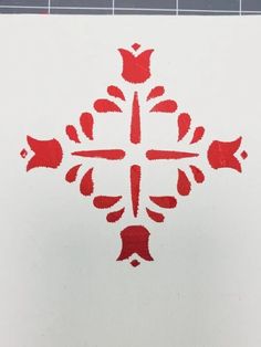 the cross is painted red on white paper