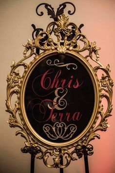 a gold framed sign that says,'this is fera'in pink lettering