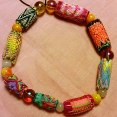 a colorful bracelet with glass beads and charms