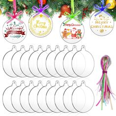 twelve christmas baubles hanging from a tree with ribbons and decorations around them, all decorated in different colors