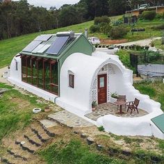 a small white house with a green roof