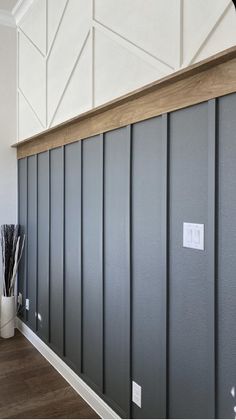 an empty room with gray paneling on the walls