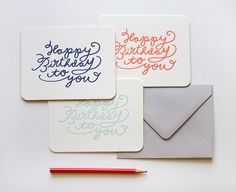 three birthday cards with writing on them next to a pencil