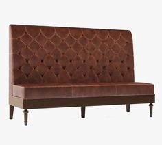 a brown leather couch sitting on top of a wooden frame