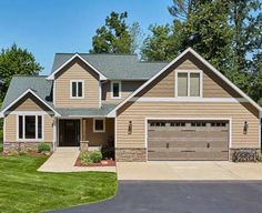 a large house with two car garages in the driveway